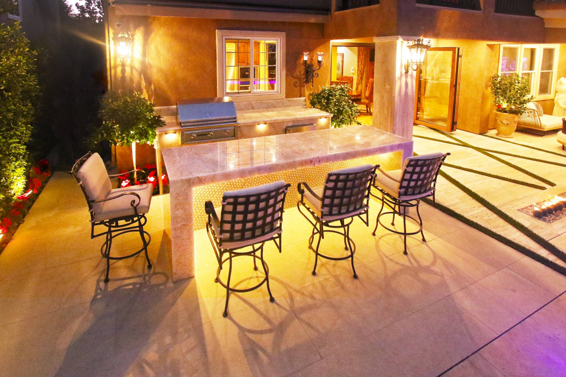 BSH Outdoor Kitchens — stone island with built-in grill and prep area