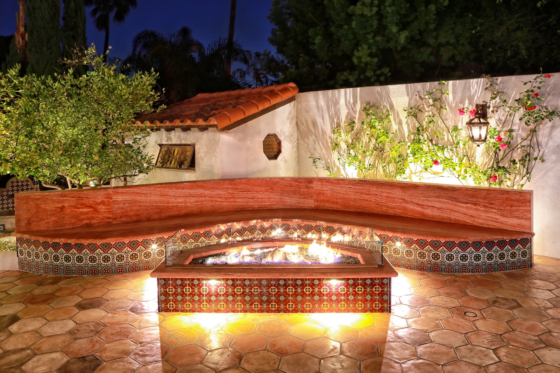 BSH Fire Features — custom stone fire pit with flames at dusk
