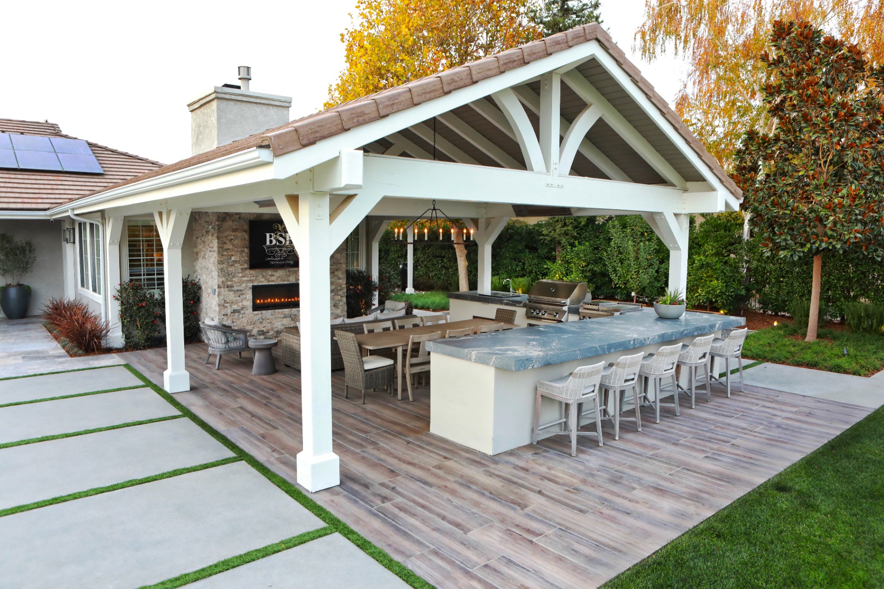 BSH Outdoor Kitchens — luxury covered outdoor kitchen with grill and bar