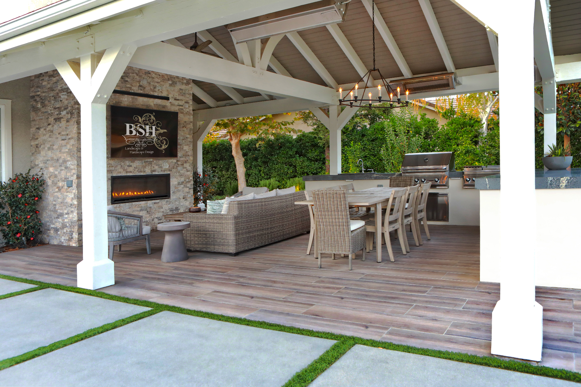BSH Outdoor Kitchens — covered pavilion with wicker lounge and stone fireplace